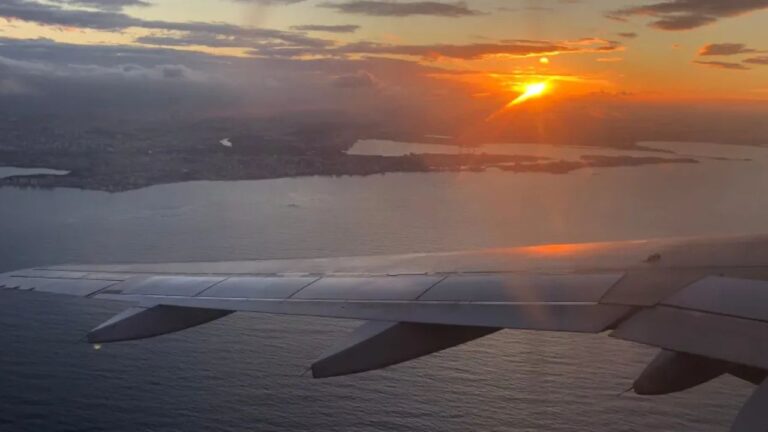 View out of the airplane window at sunset