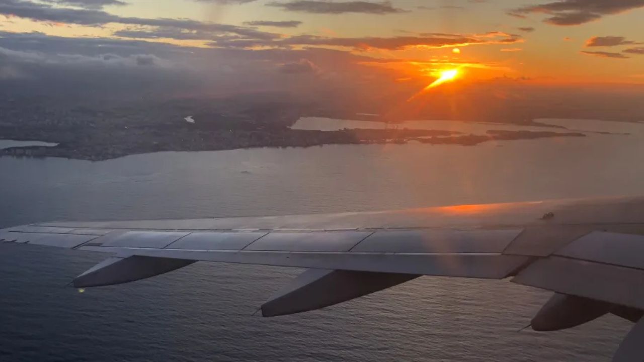 View out of the airplane window at sunset