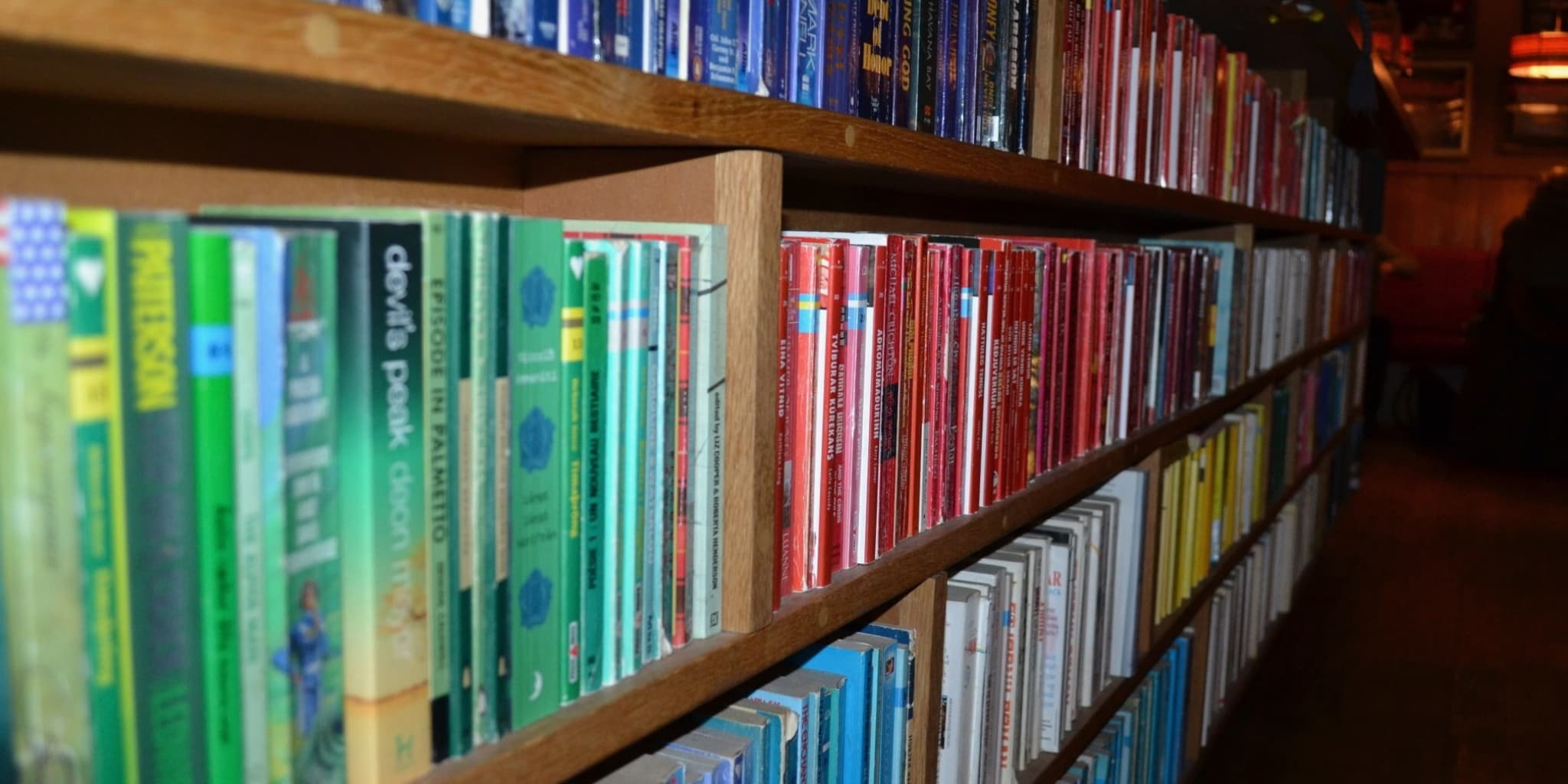 Books for sale on a shelf in a cafe