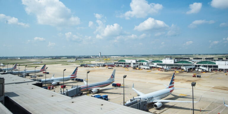 The tarmac at O'Hare Airport with planes in the foreground and background